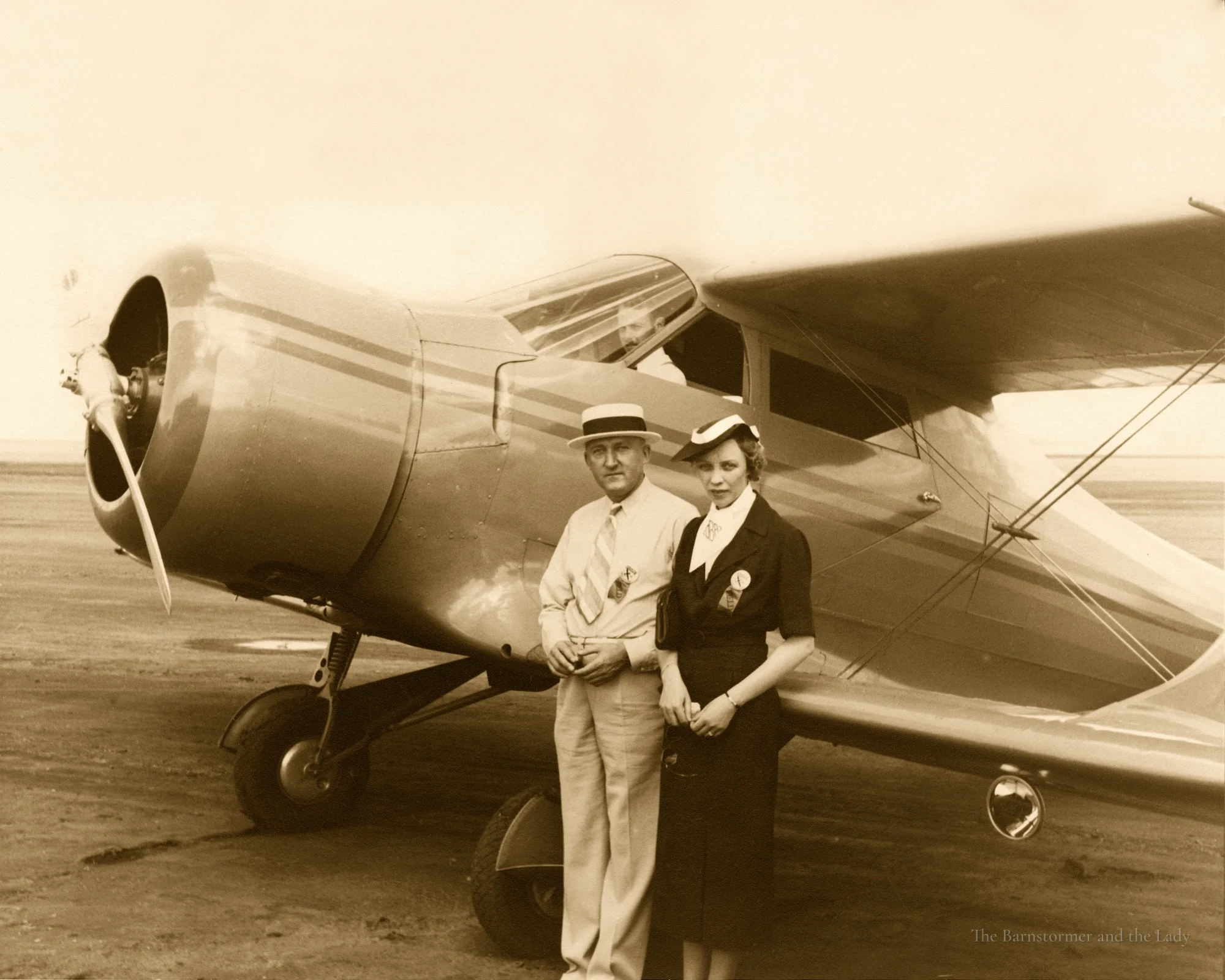 Walter and Olive Ann Beech standing in front of a Staggerwing