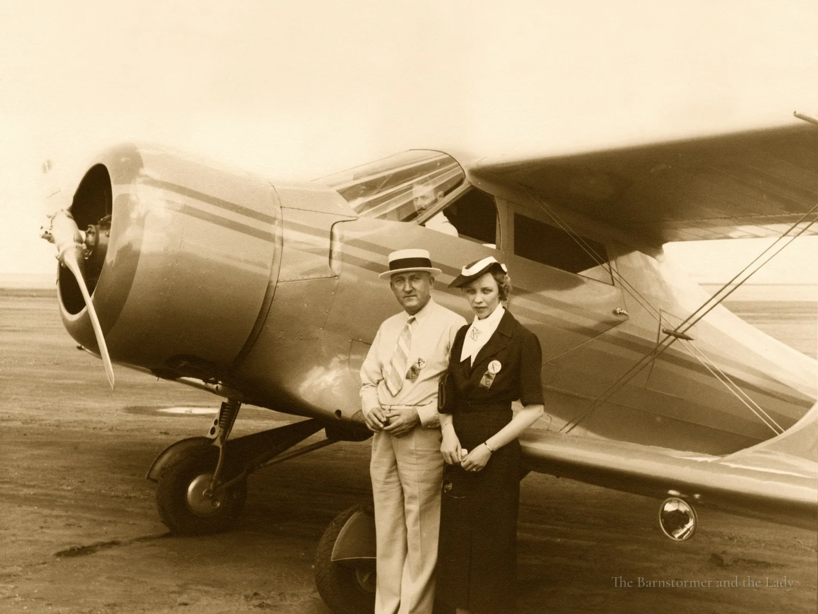 Walter and Olive Ann Beech standing in front of a Staggerwing